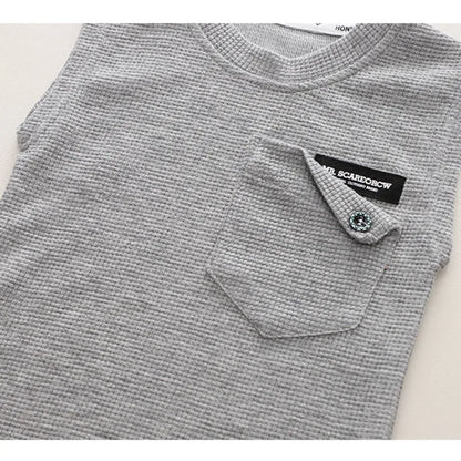 Detail of the neckline on a toddler boy's blue sleeveless cotton top, designed for comfort and ease of movement.