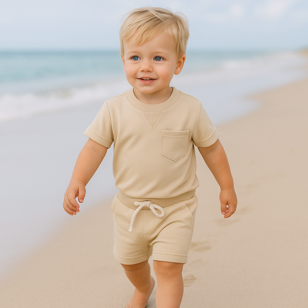 Toddler boy in cool blue cotton t-shirt and shorts summer outfit, ideal for casual play.