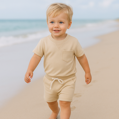 Toddler boy in cool blue cotton t-shirt and shorts summer outfit, ideal for casual play.