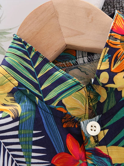 Close-up of boys' cotton summer set, white top with green leaf & blue floral print pattern for kids.