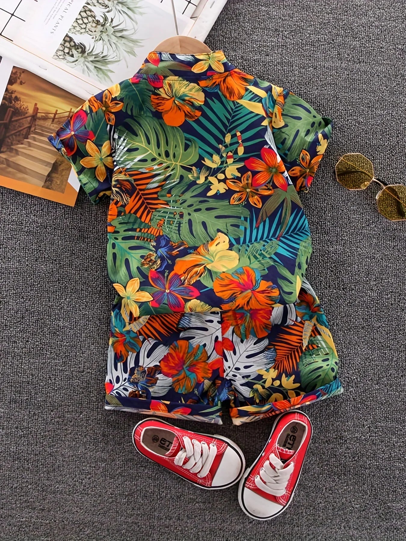Children's fashion: short sleeve shirt and shorts set with vibrant leaf and floral print for summer.