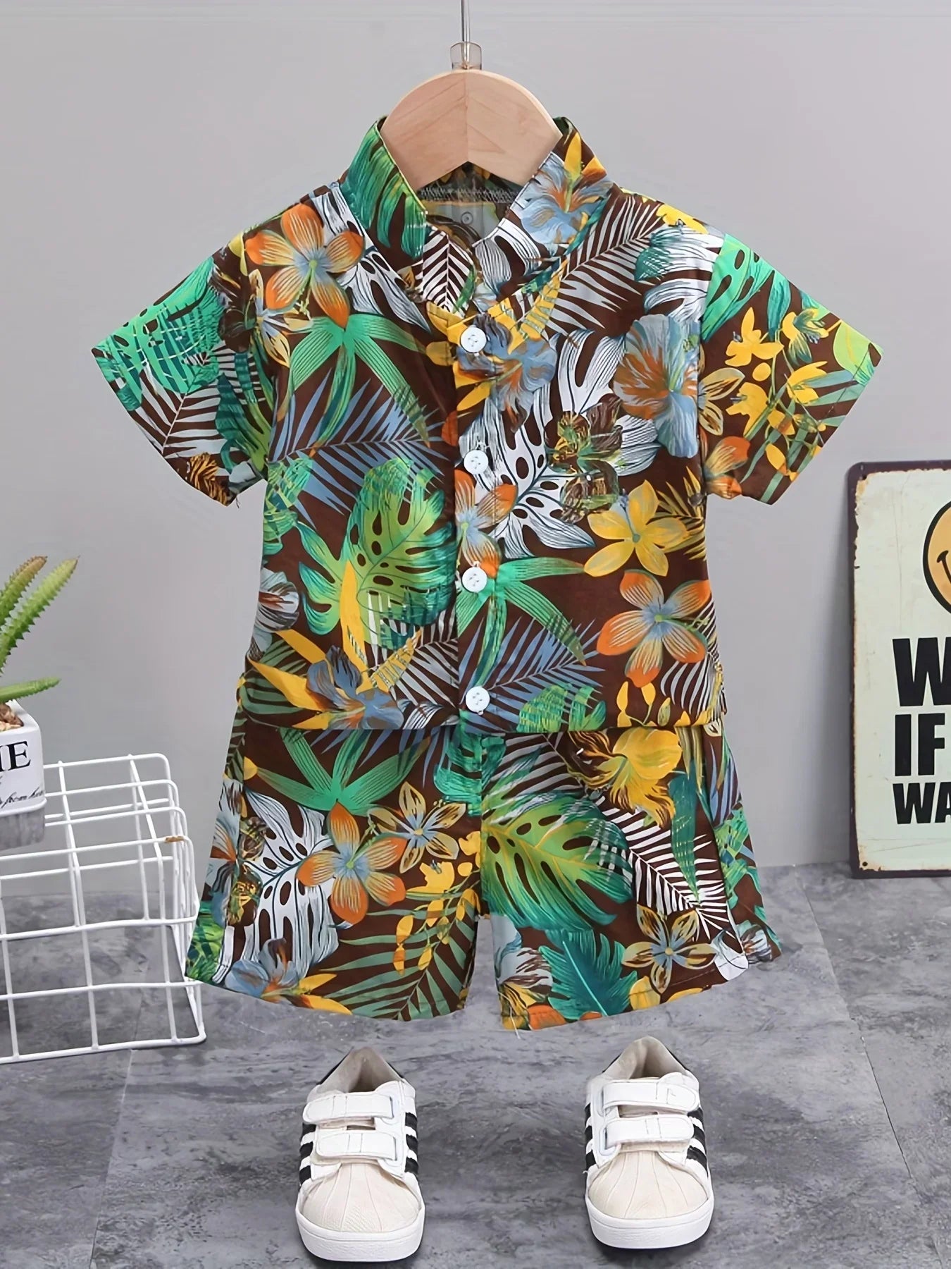 Front view of children's summer set showing white short-sleeve top and shorts with leaf & flower print.