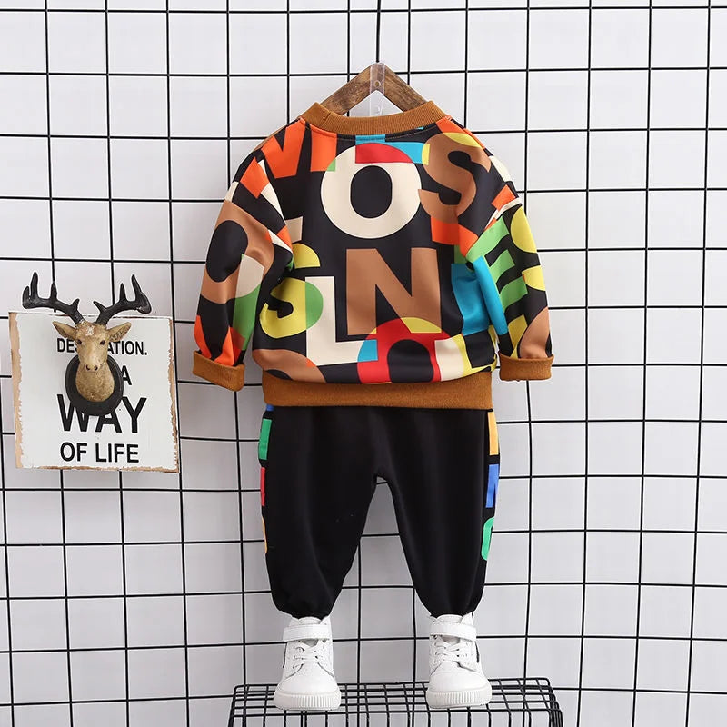Close-up of the soft cotton fabric of the long-sleeve t-shirt in a toddler boy's casual set.