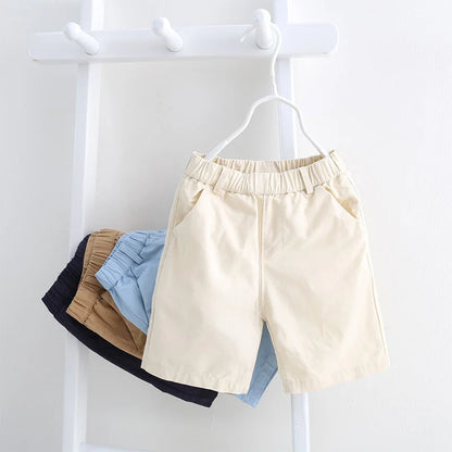Close-up of elastic waistband on kids' blue cotton shorts for comfortable summer play.