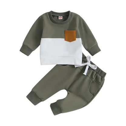 Overhead view of a folded toddler boys' tracksuit, showcasing its soft cotton blend material