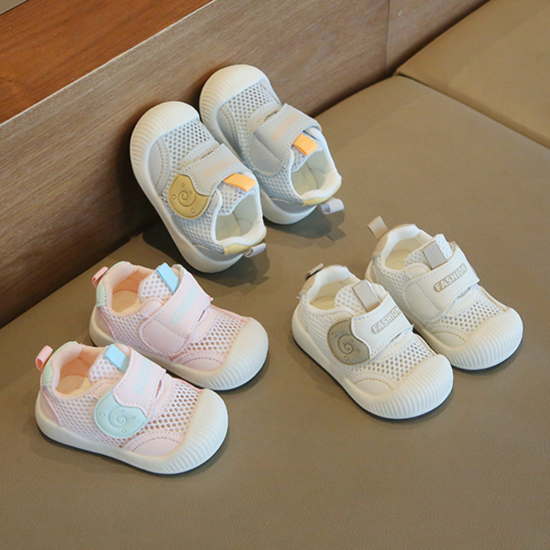Toddler's white breathable mesh first walker sneakers, designed for comfortable early steps and active play.