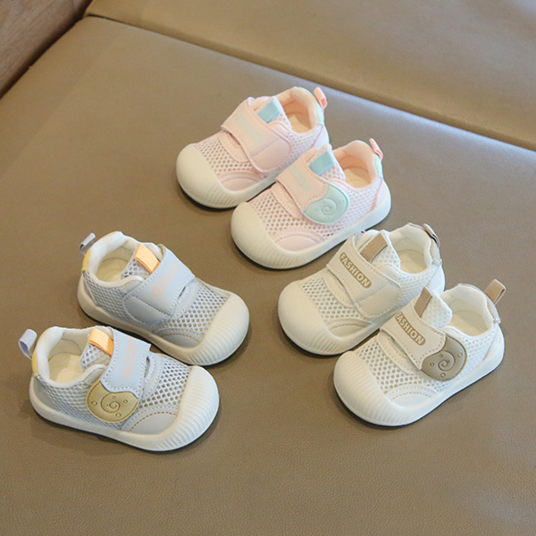 Close-up of toddler's blue breathable mesh first walker sneakers, showcasing a non-slip sole for safety.