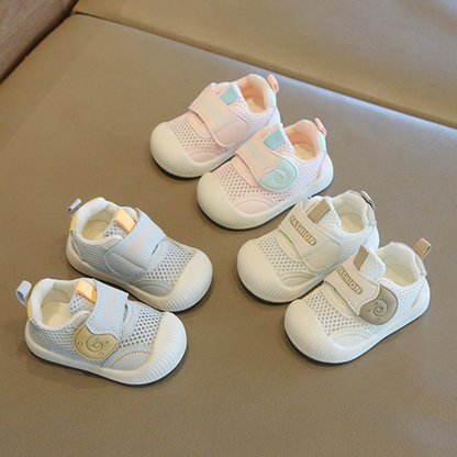 Close-up of toddler's blue breathable mesh first walker sneakers, showcasing a non-slip sole for safety.