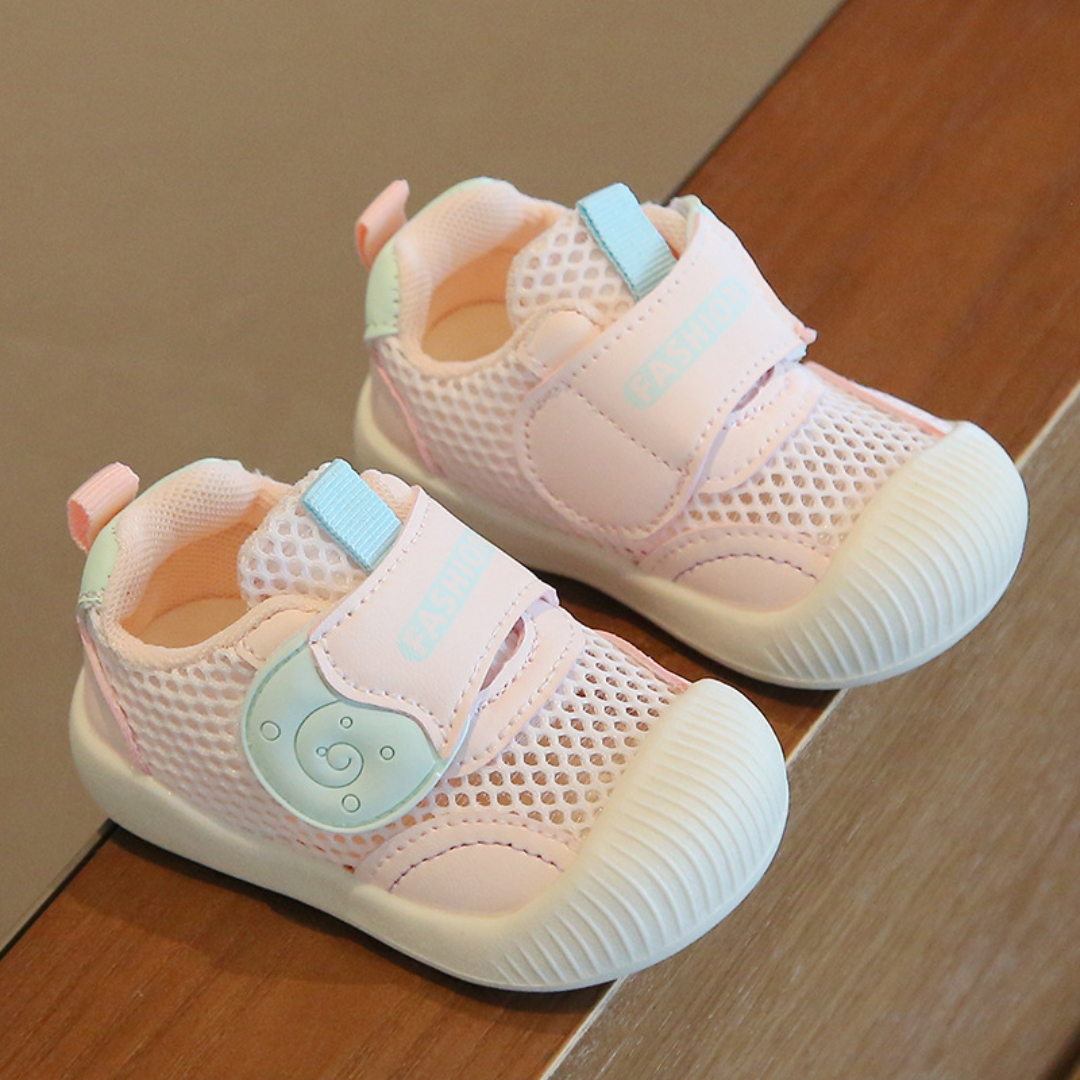 Pair of pink breathable mesh first walker sneakers for baby girls, offering optimal comfort and support.