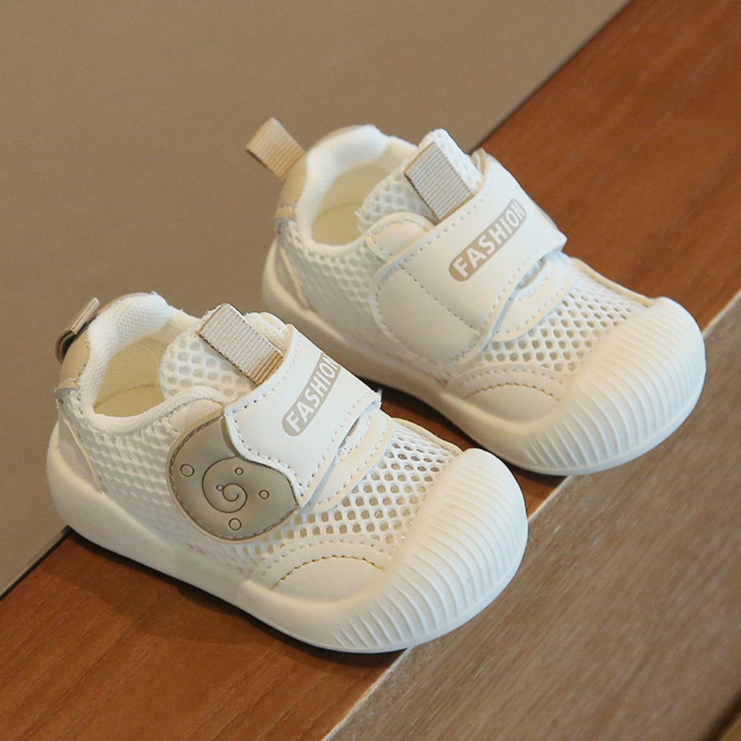 Side view of black toddler's breathable mesh first walker sneakers, emphasizing durability for active toddlers.
