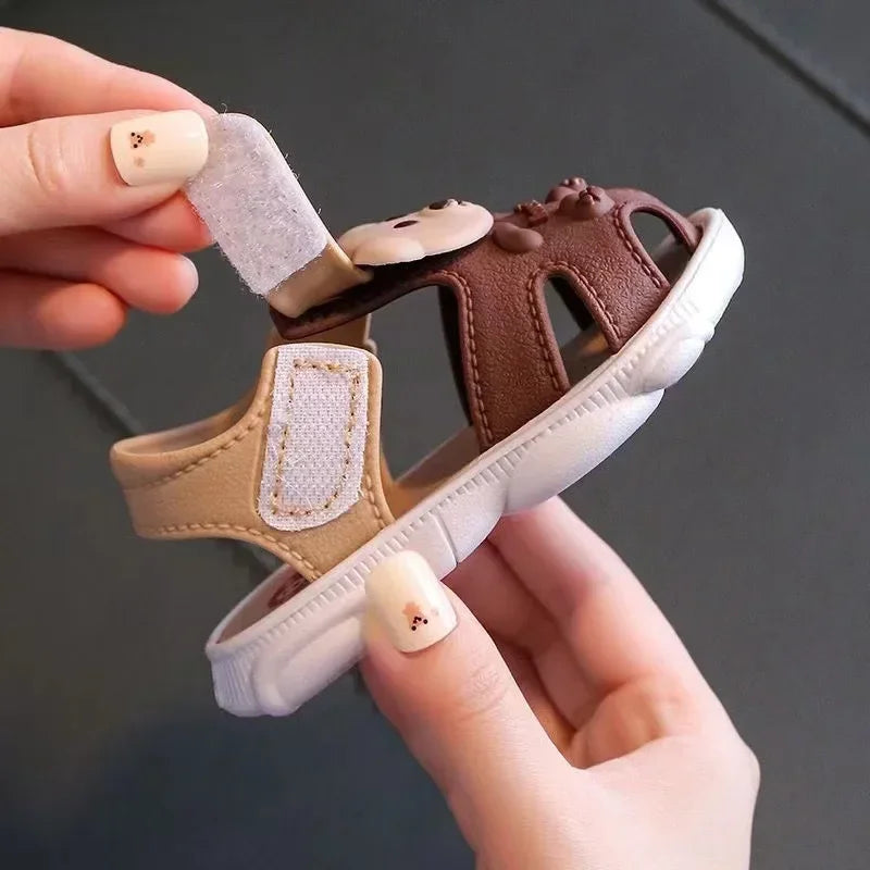 Toddler boy wearing blue cartoon beach sandals, ideal for summer play and outdoor activities
