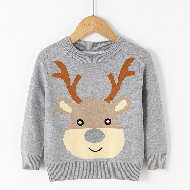 Smiling child in a warm reindeer knitwear sweater suitable for Christmas