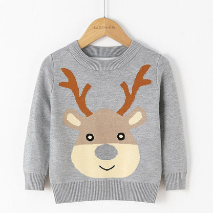 Smiling child in a warm reindeer knitwear sweater suitable for Christmas