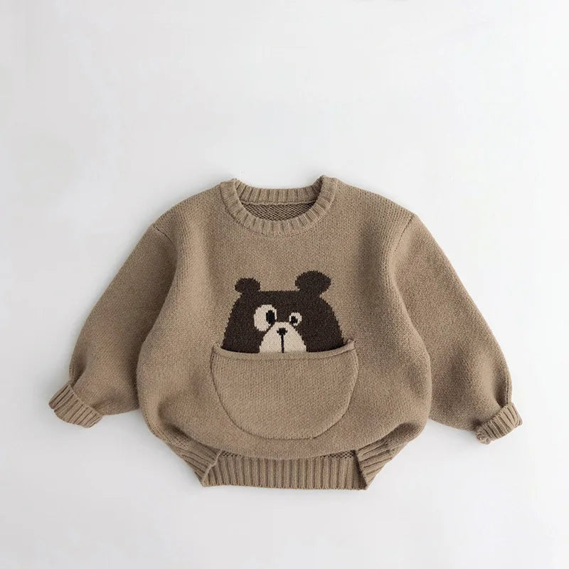 Side profile of a childrens animal print cotton sweater, showcasing its pouch pocket.