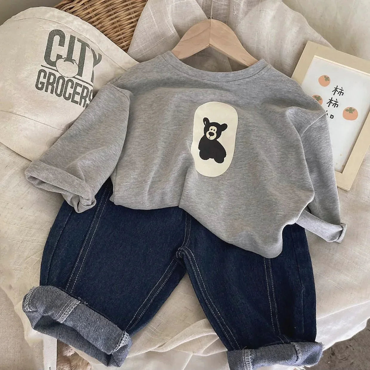 Soft cotton baby sweatshirt featuring an adorable bear graphic, great for cozy all-day wear.