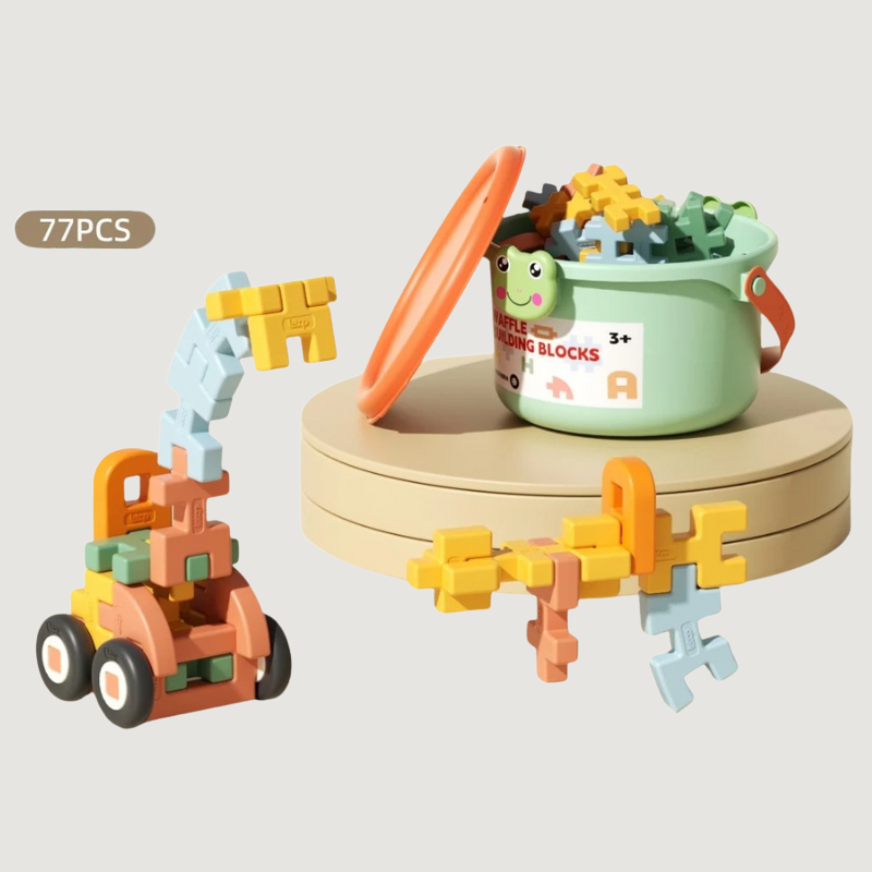 Happy toddler boy building a tower with colorful Creative Building Blocks, educational construction set
