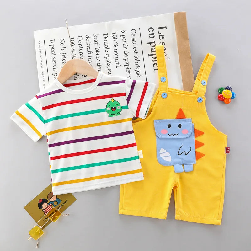Close-up of a blue dinosaur print on a child's summer t-shirt and romper cotton set.