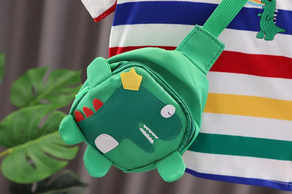 The complete child's dinosaur T-shirt, shorts, and bag set on a hanger