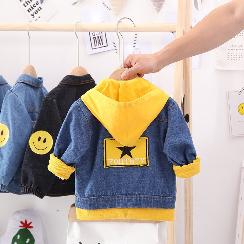 Front view of a warm baby cotton jacket with a fun dog print, functional zipper, and cozy hood.