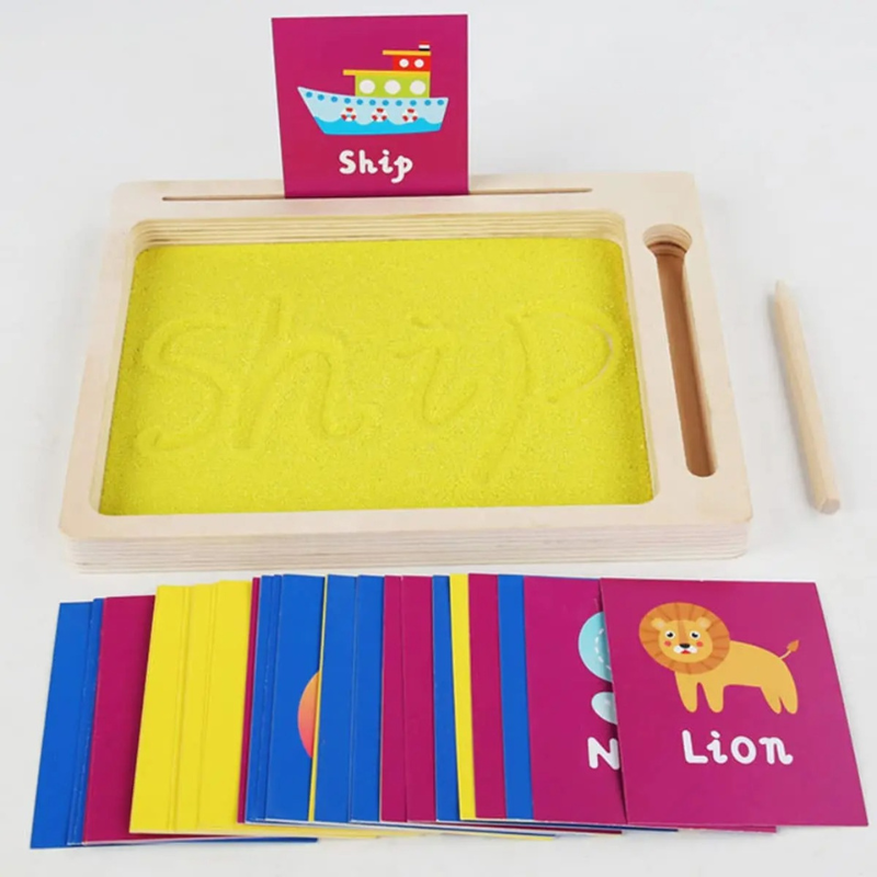 Toddler drawing on a Montessori sand board, enhancing fine motor skills with creative play