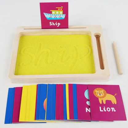 Toddler drawing on a Montessori sand board, enhancing fine motor skills with creative play