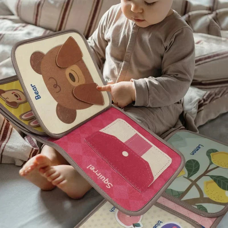 Toddler engaged with colorful Montessori busy book, learning shapes & colors, a great travel toy