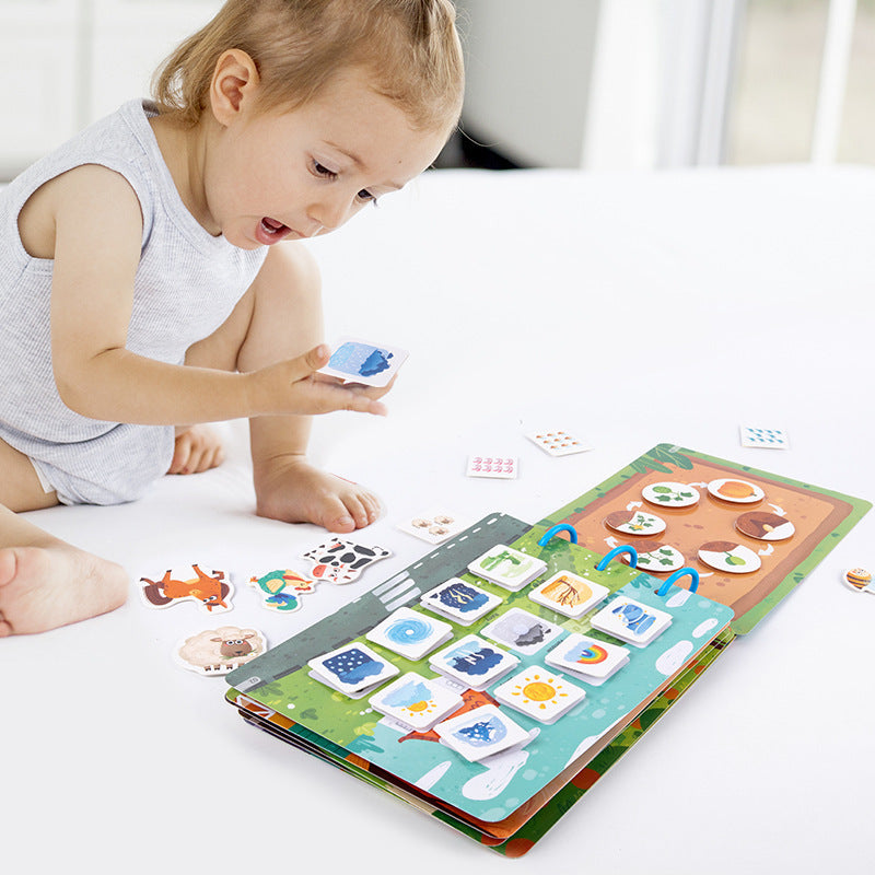 Toddler engaged with colorful Quiet Book, learning shapes and colors, educational toy for 3+ years
