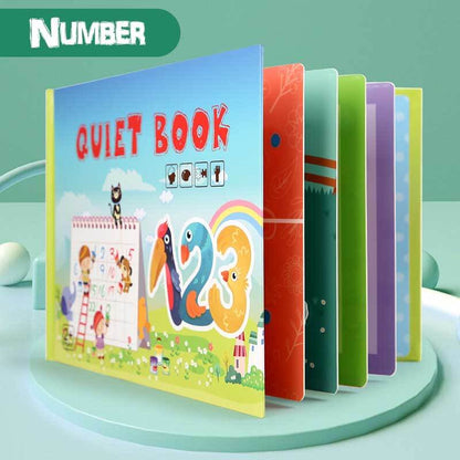 Toddler boy happily engaging with a felt stacking activity in his quiet book, learning colors and shapes