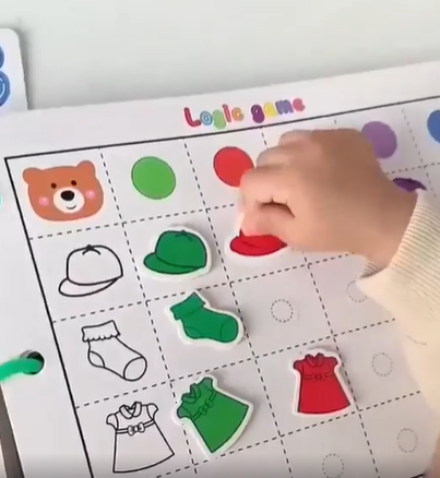 Unisex kids learning through interactive pages of a waterproof cognitive activity scrapbook.