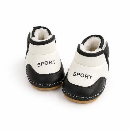 Close-up of black toddler winter boots, anti-slip sole detail, waterproof for snowy conditions.