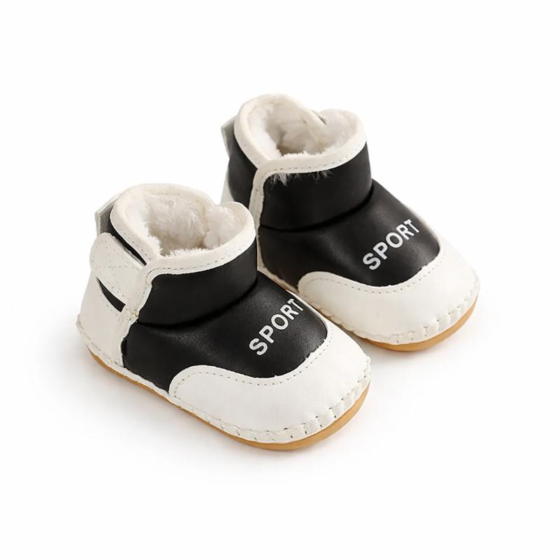 Pair of white and black toddler first steps boots, waterproof and anti-slip for winter outdoor play.