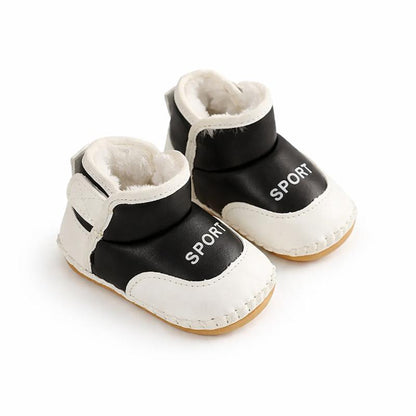 Pair of white and black toddler first steps boots, waterproof and anti-slip for winter outdoor play.
