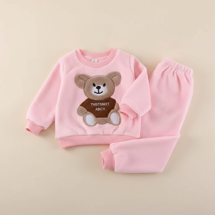 Happy toddler playing outdoors in warm bear print winter set, kids winter clothing
