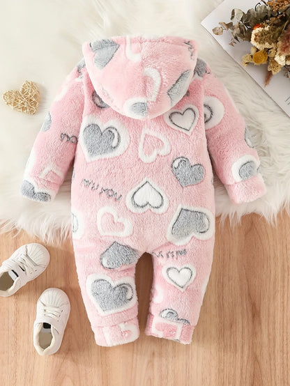 Close-up of fuzzy pink heart pattern on baby hooded winter romper, soft polyester