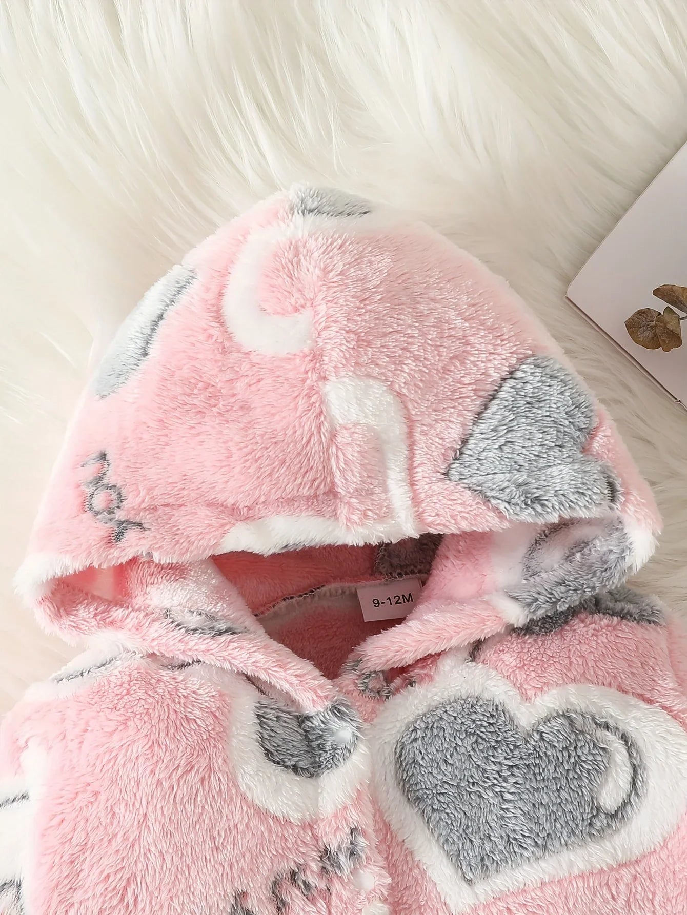 Baby wearing pink heart hooded romper, front view, perfect cozy winter outfit