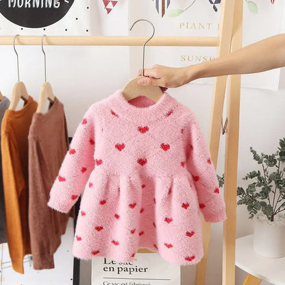 Soft cotton fleece dress for girls, in a vibrant pink, ideal for winter fashion and comfort.