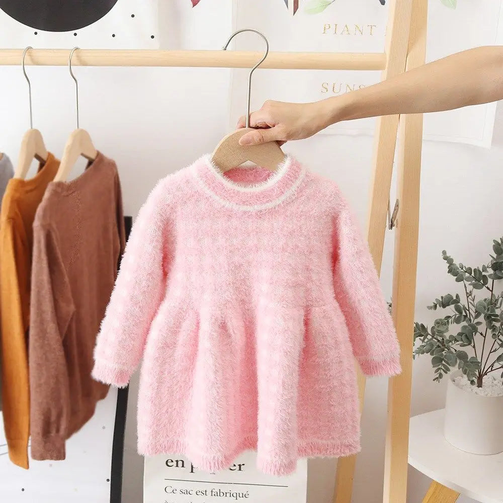 Close-up of a pink fleece toddler dress, showcasing the soft texture and warm winter style.