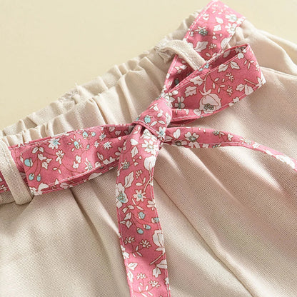 Durable and soft toddler girl's summer outfit featuring a floral blouse and plain pants.