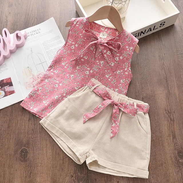 Kids' summer fashion: a delightful floral print blouse paired with solid color pants for toddlers.