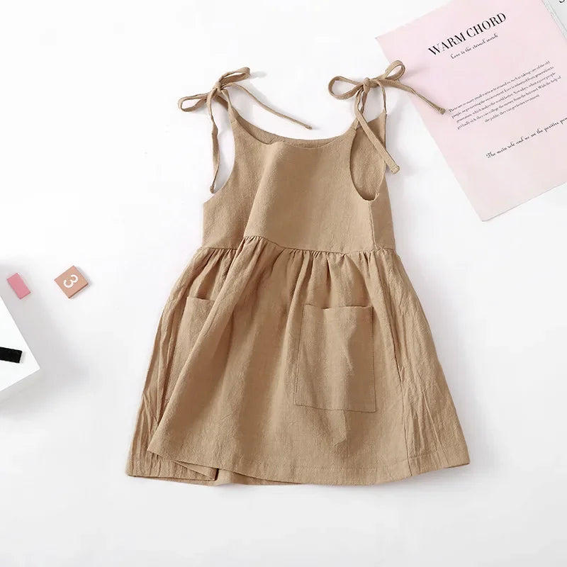 Stack of colorful lightweight cotton sleeveless dresses for toddler girls, perfect for summer.