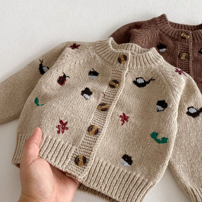 Close-up of a warm wool and mohair blend girls' cartoon sweater, soft kids knitwear