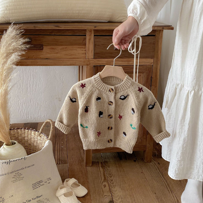 Playful cartoon design on a cozy girls' wool blend sweater, ideal toddler autumn wear