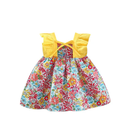 Flat lay of a girls' summer floral dress and a matching sun hat, perfect for toddlers.