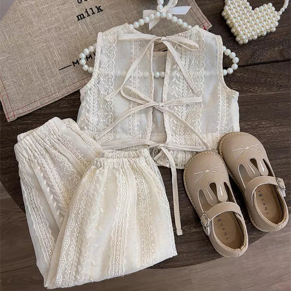 Girls summer fashion: toddler in a white hollow lace two-piece set, ready for play