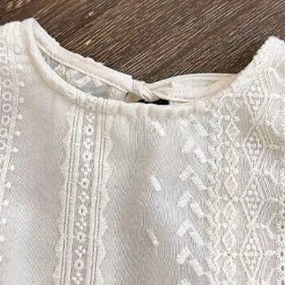Smiling toddler girl wearing a white hollow lace summer shorts set, casual girls apparel