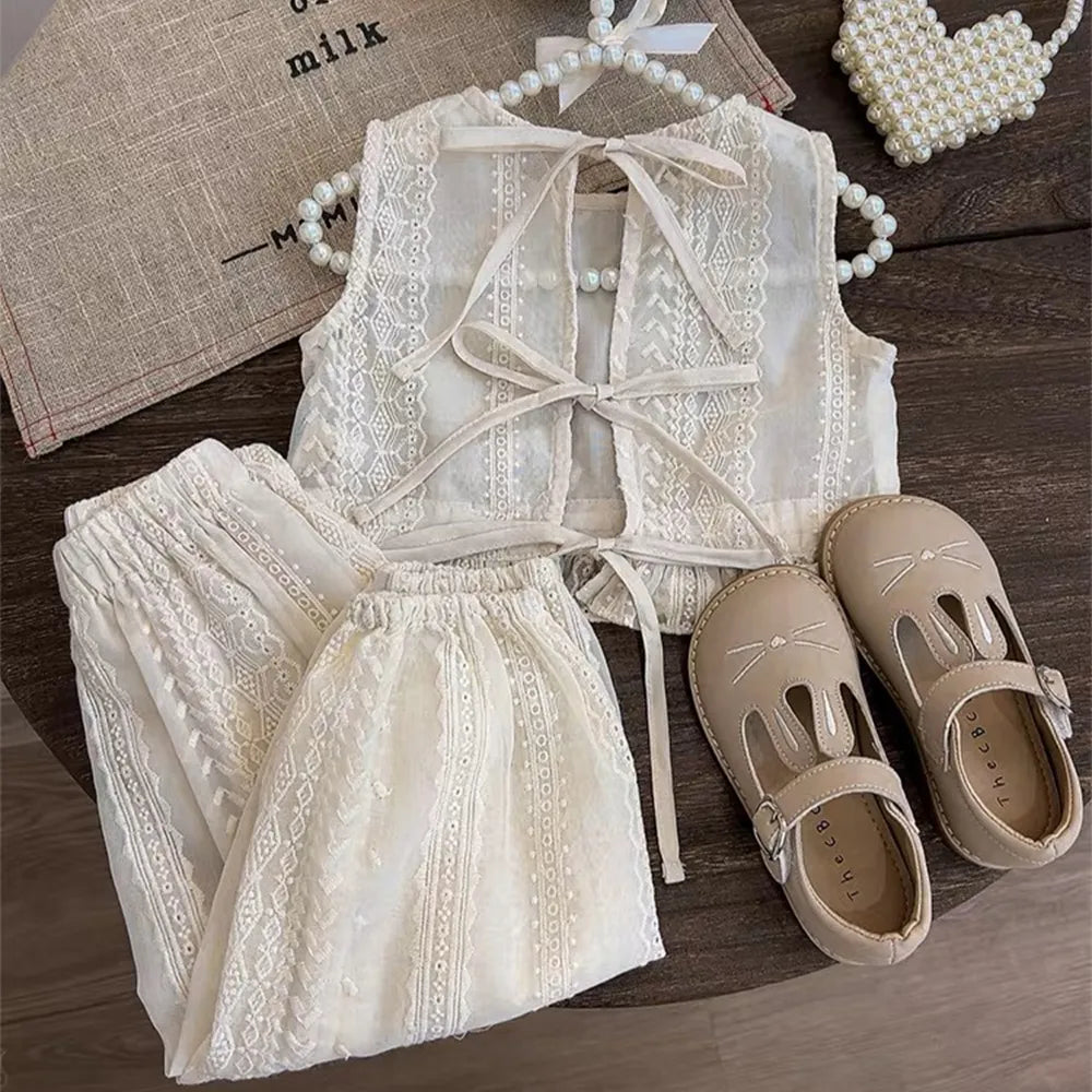 Toddler girl posing in a blue hollow lace summer shorts set, ideal for warm weather