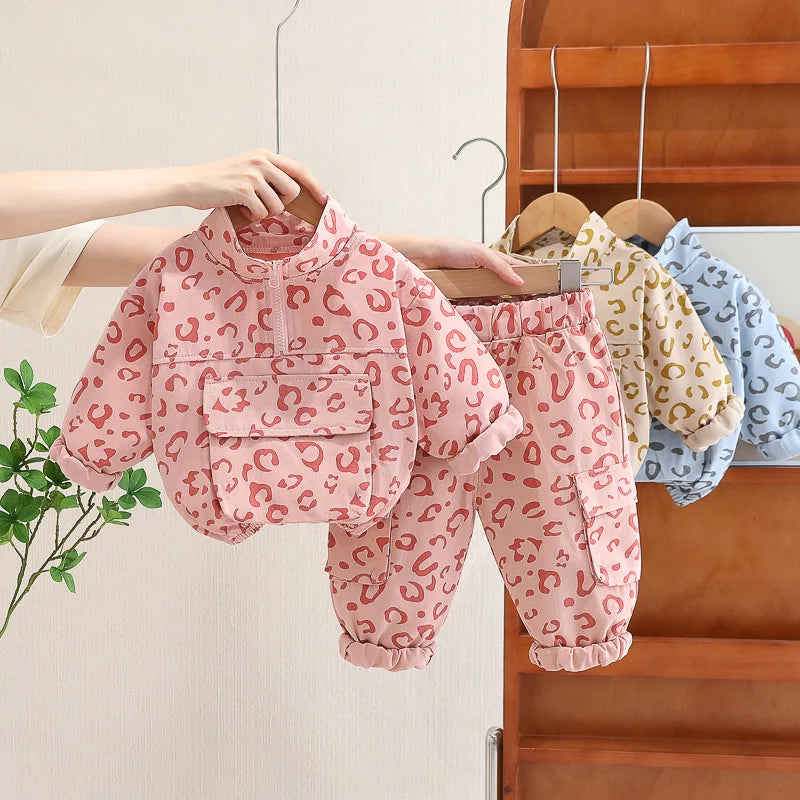 Toddler girl in leopard print sweatshirt and pants set, perfect for fall playwear, front view.