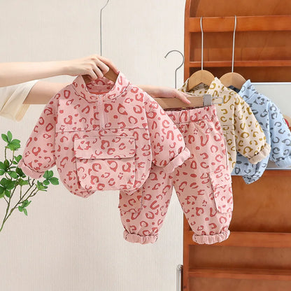 Toddler girl in leopard print sweatshirt and pants set, perfect for fall playwear, front view.