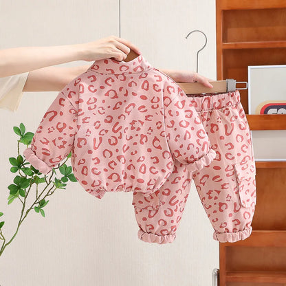 Back view of a child wearing a cozy leopard print two-piece set, suitable for everyday infants.