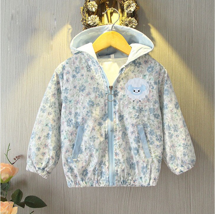 Detailed shot of the zipper and floral pattern on a toddler girls' cotton windbreaker.